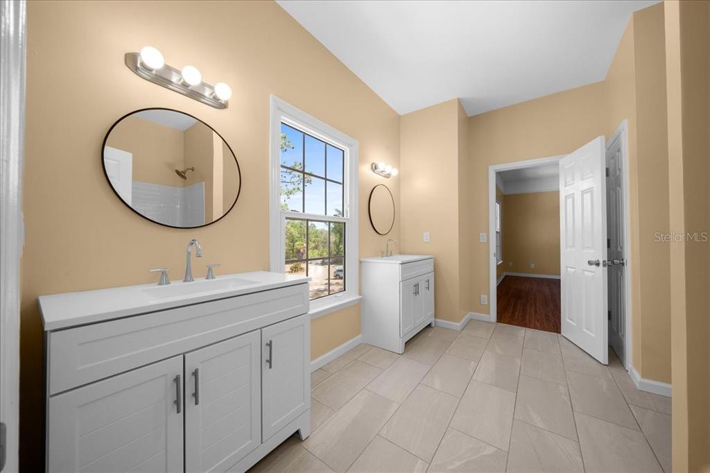 7808 Northeast 75th Street Gainesville, FL 32609 - Photo 46 of 78 a bathroom with a sink a toilet and a mirror