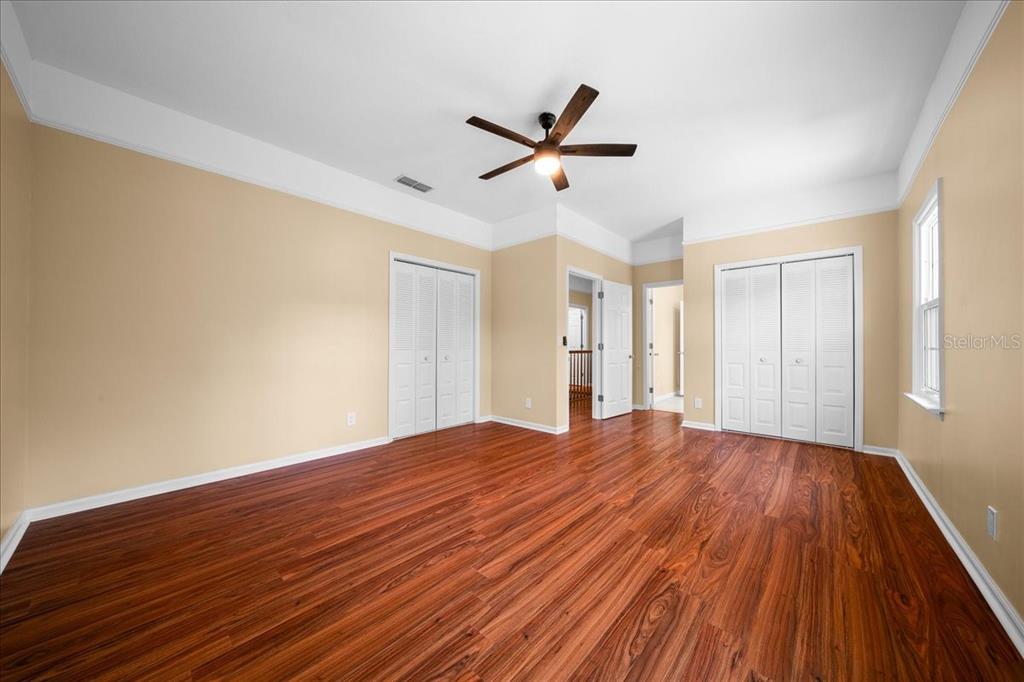7808 Northeast 75th Street Gainesville, FL 32609 - Photo 52 of 78 a view of empty room with wooden floor and fan