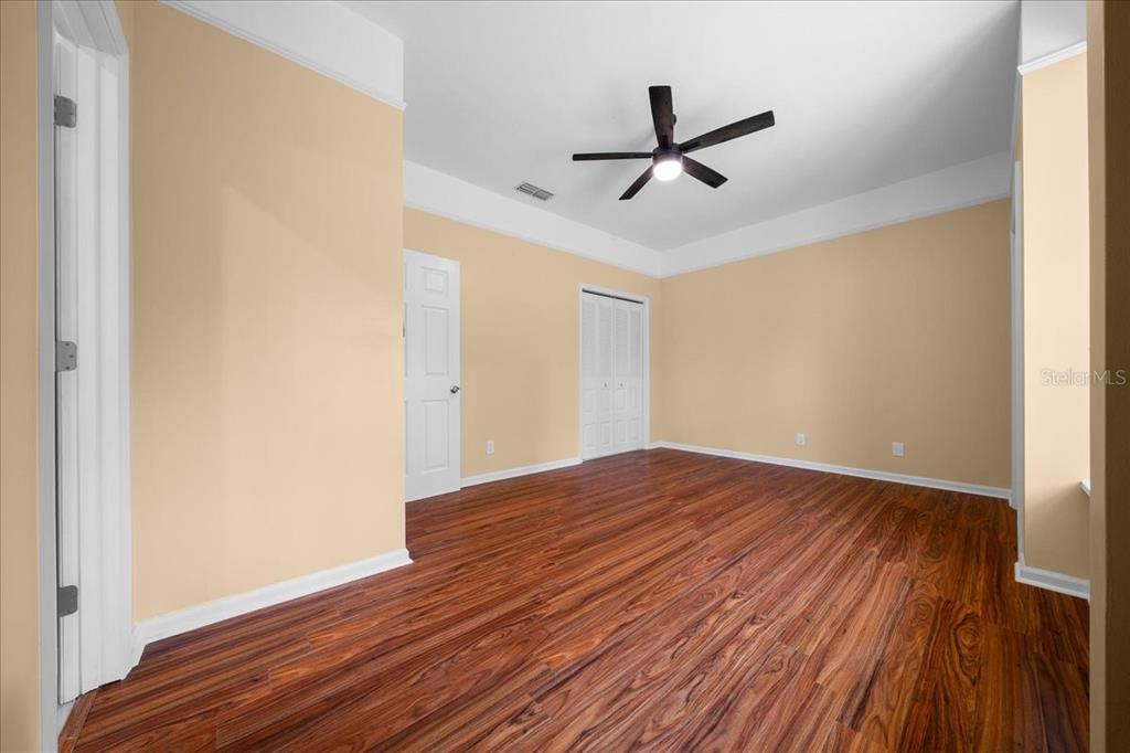 7808 Northeast 75th Street Gainesville, FL 32609 - Photo 56 of 78 a view of empty room with wooden floor and ceiling fan