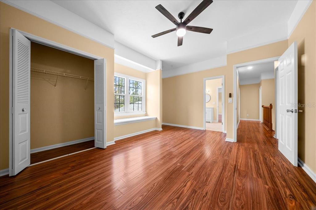 7808 Northeast 75th Street Gainesville, FL 32609 - Photo 57 of 78 an empty room with wooden floor and windows