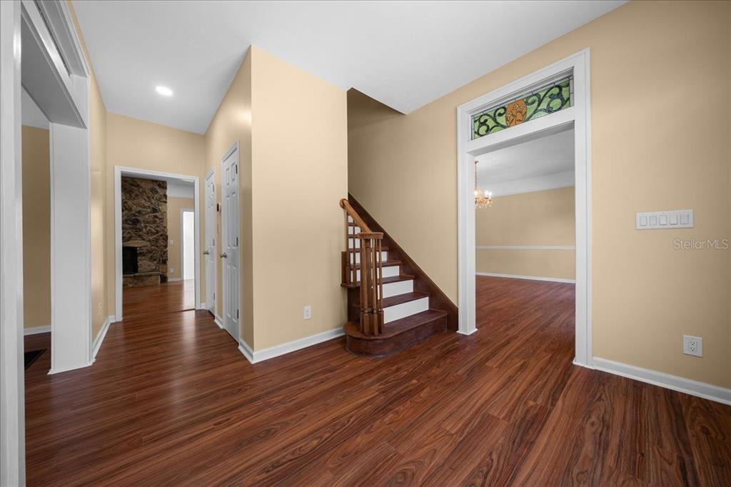 7808 Northeast 75th Street Gainesville, FL 32609 - Photo 8 of 78 a view of a hallway with wooden floor and staircase