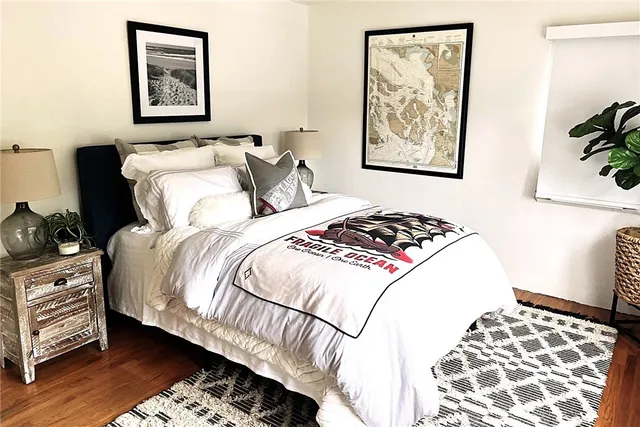 a bedroom with bed and painting on the wall