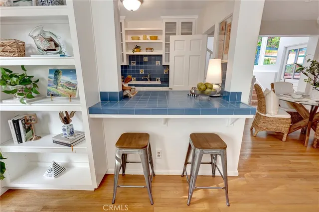 a dining room with kitchen island a table and chairs