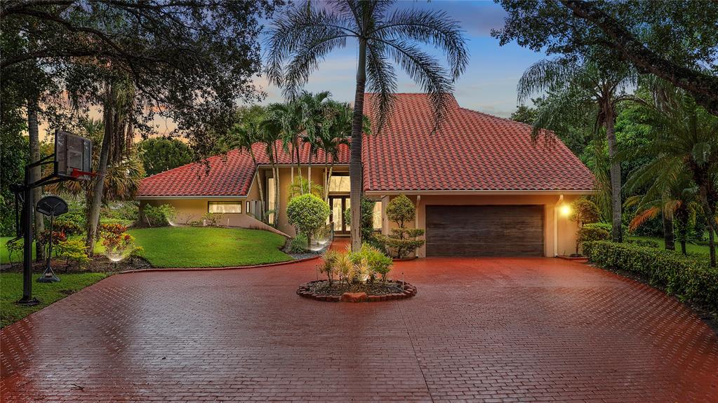 a view of a house with a yard and garage
