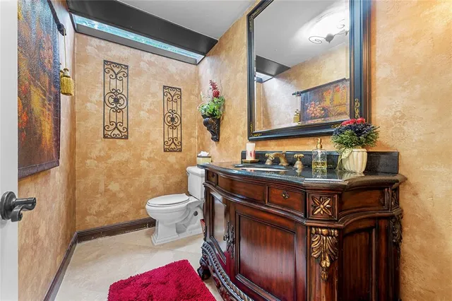 a bathroom with a sink a toilet and mirror