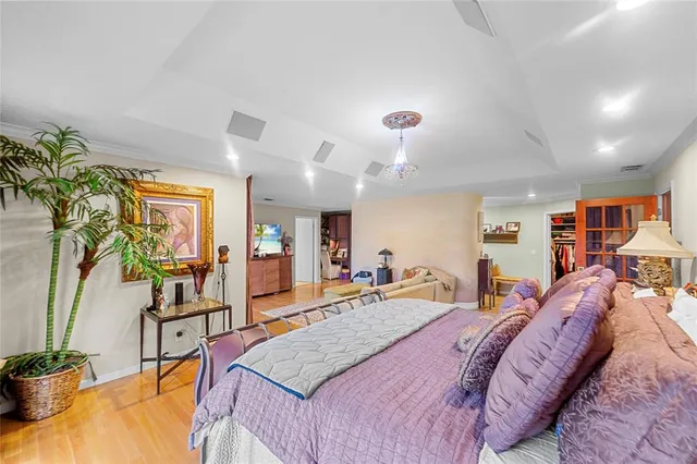 a bed room with a bed window and potted plant