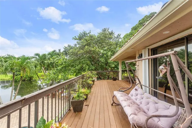 a view of swimming pool with outdoor seating and plants