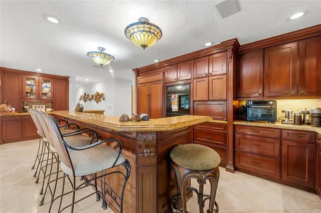 a dining room filled chandelier and wooden floor
