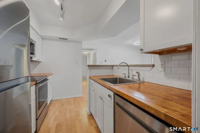 a kitchen with a sink stove and cabinets