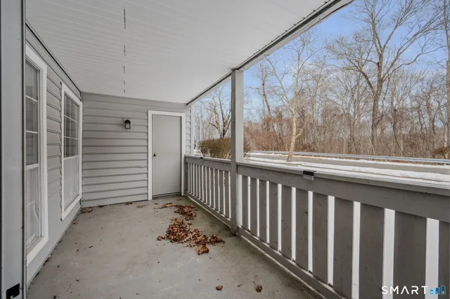 a view of a porch with wooden floor and stairs