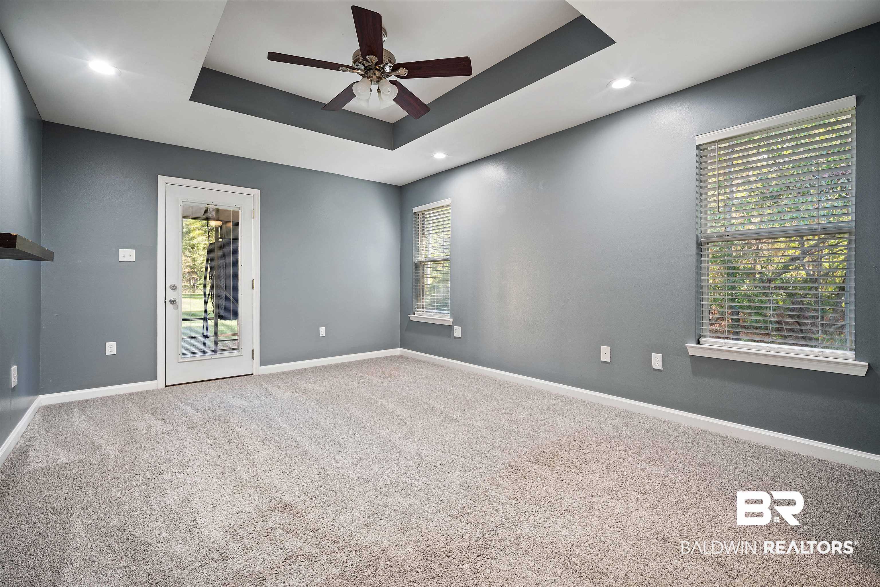 3010 Drag Strip Lane Coden, AL 36523 - Photo 16 of 44 Primary bedroom room featuring ceiling fan, a healthy amount of sunlight, and a raised ceiling