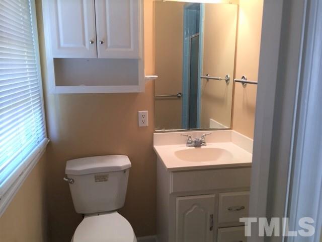 4513 Limerick Drive Raleigh, NC 27604 - Photo 14 of 19 a bathroom with a toilet sink and mirror