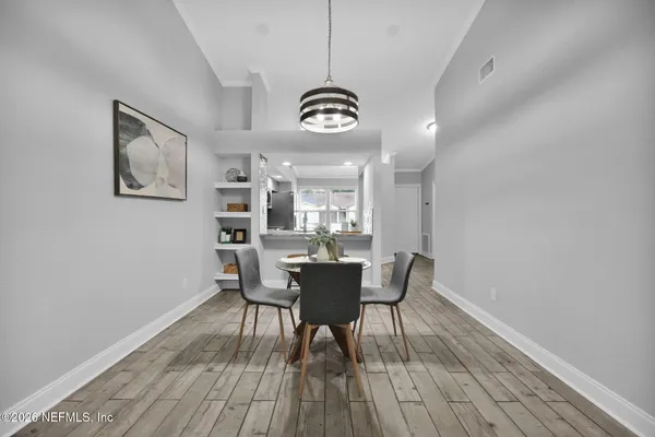 a view of a dining room with furniture and wooden floor