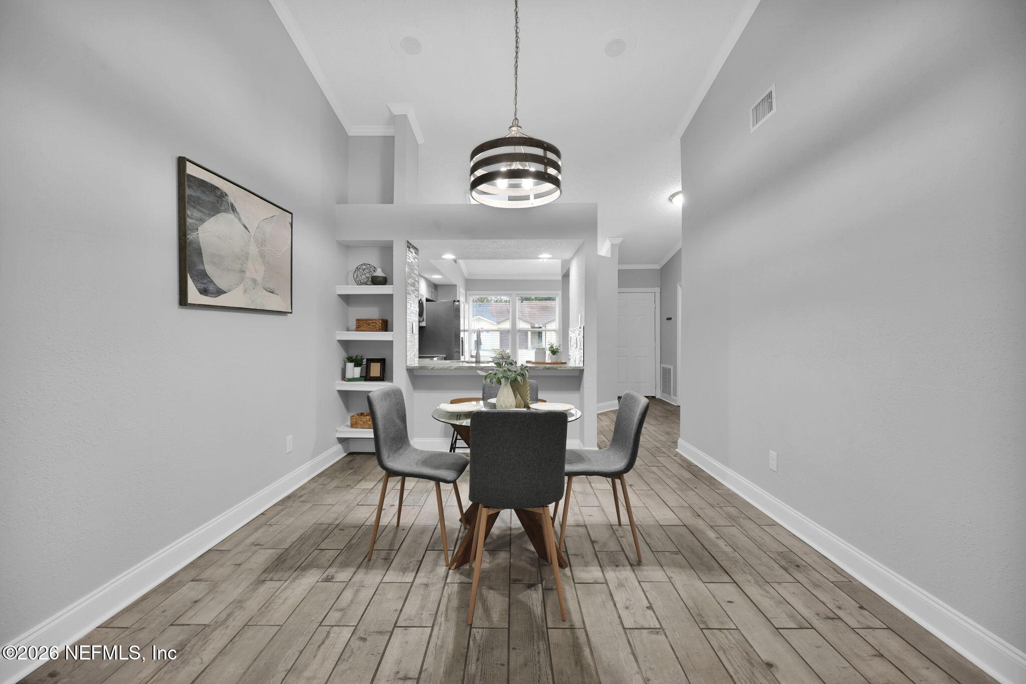 2494 Spring Vale Road Jacksonville, FL 32246 - Photo 13 of 36 a view of a dining room with furniture and wooden floor