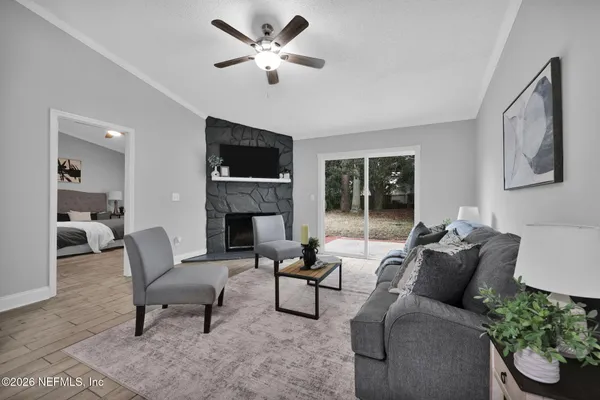 a living room with furniture a flat screen tv and a fireplace