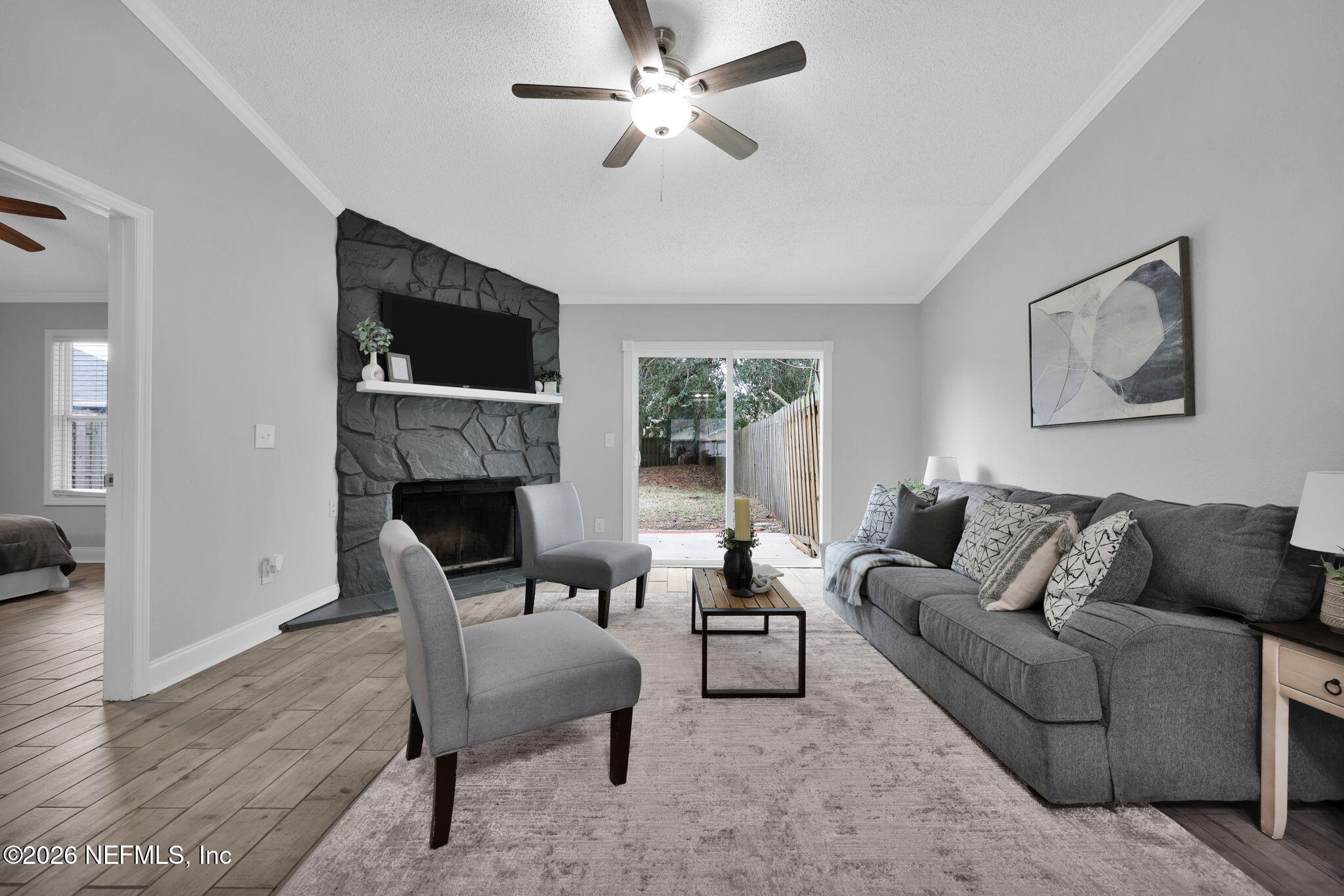 2494 Spring Vale Road Jacksonville, FL 32246 - Photo 16 of 36 a living room with furniture a flat screen tv and a fireplace