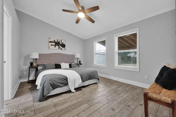 a spacious bedroom with a bed and window