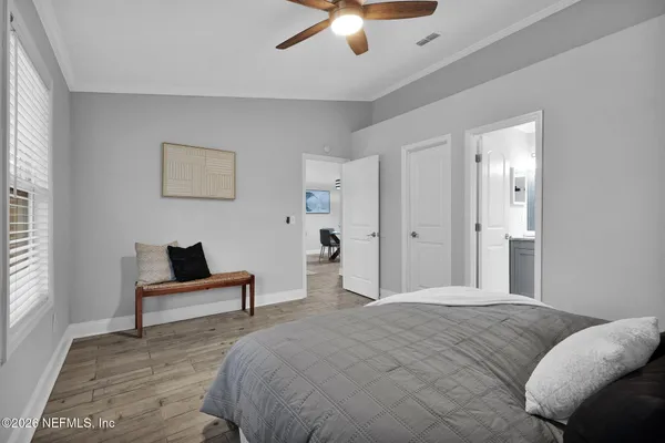 a bedroom with a bed and a ceiling fan