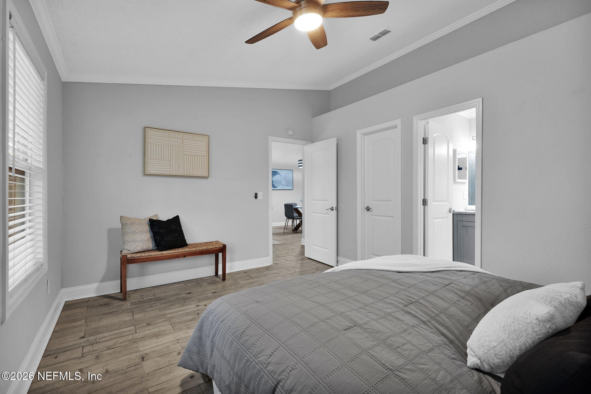 2494 Spring Vale Road Jacksonville, FL 32246 - Photo 19 of 36 a bedroom with a bed and a ceiling fan