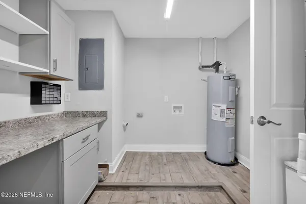 a bathroom with a granite countertop shower a sink and a mirror