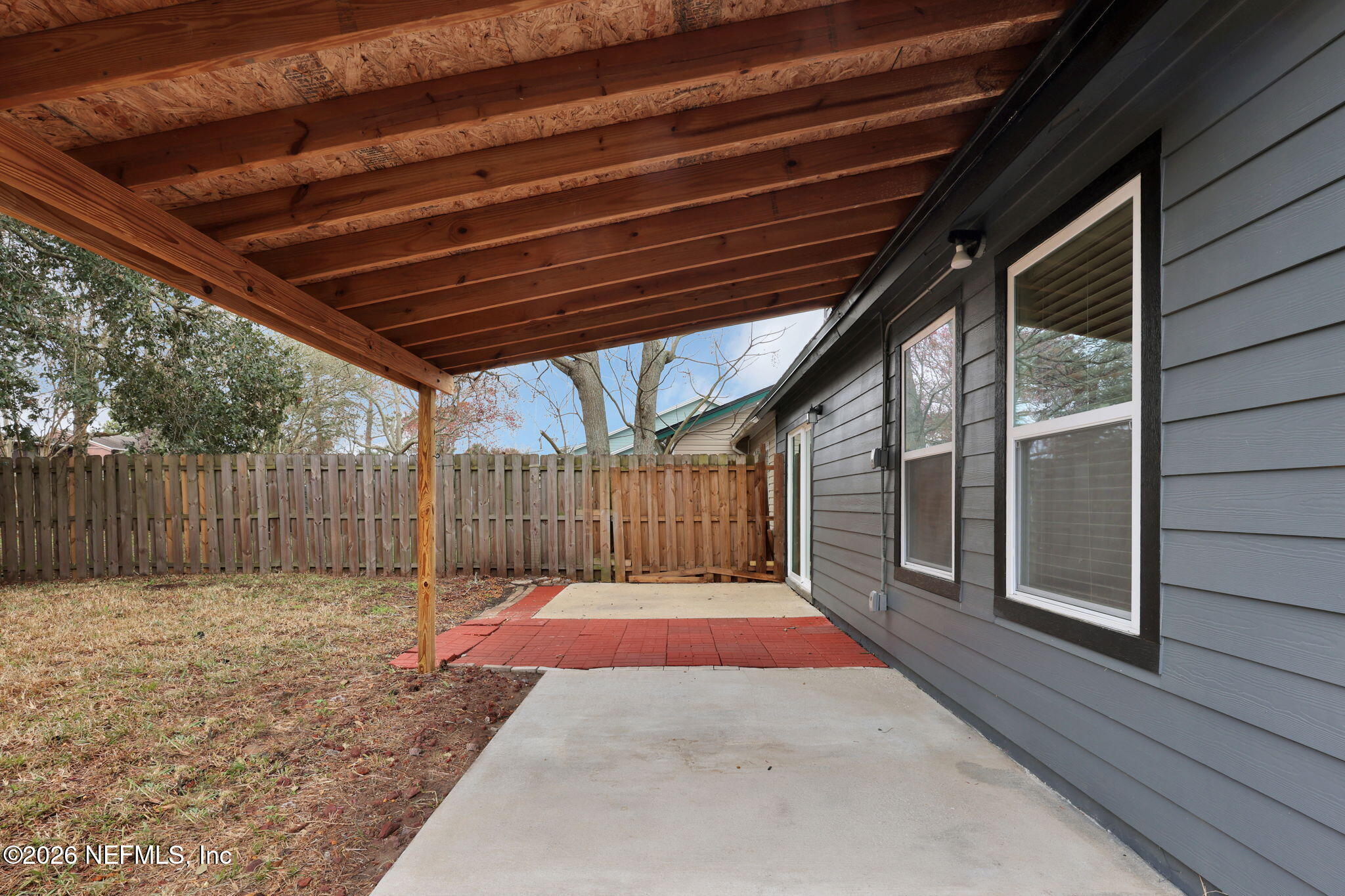 2494 Spring Vale Road Jacksonville, FL 32246 - Photo 31 of 36 a view of backyard with large trees and wooden fence