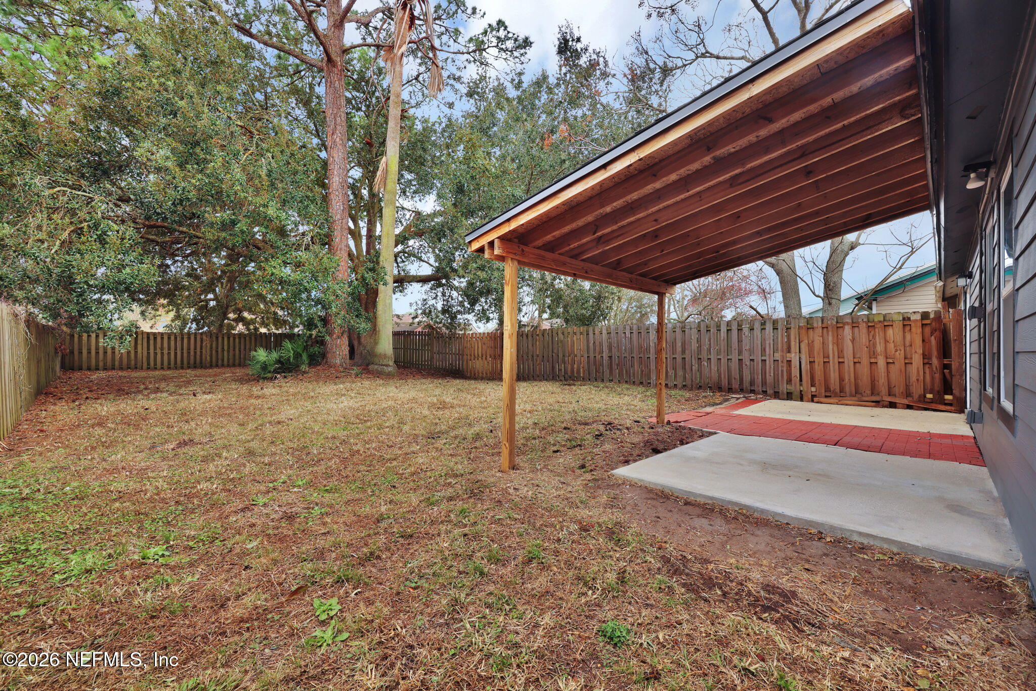 2494 Spring Vale Road Jacksonville, FL 32246 - Photo 32 of 36 a backyard of a house with lots of green space