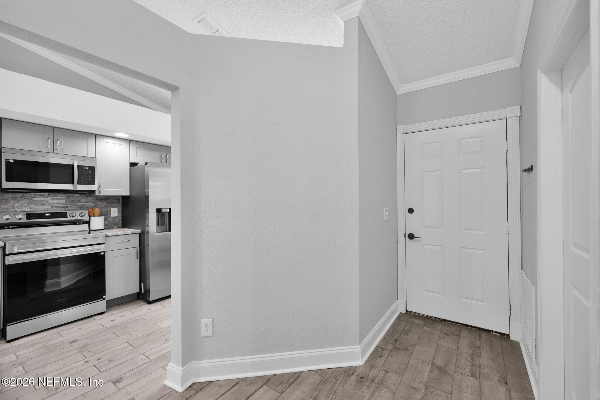 2494 Spring Vale Road Jacksonville, FL 32246 - Photo 6 of 36 a view of a kitchen from a hallway