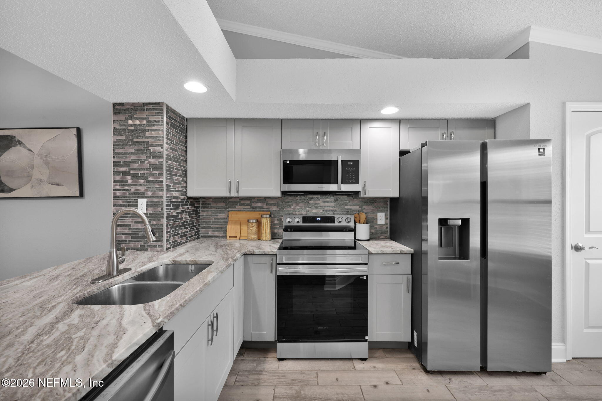 2494 Spring Vale Road Jacksonville, FL 32246 - Photo 7 of 36 a kitchen with a sink stove and refrigerator