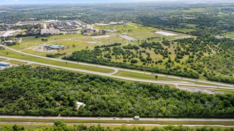 an aerial view of residential houses with outdoor space and lake view