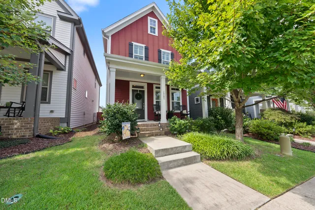 a kitchen with stainless steel appliances a refrigerator a stove a sink dishwasher a oven with white cabinets and wooden floor