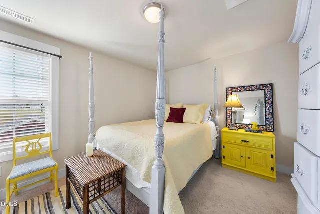 a bathroom with a sink a toilet a mirror and shower