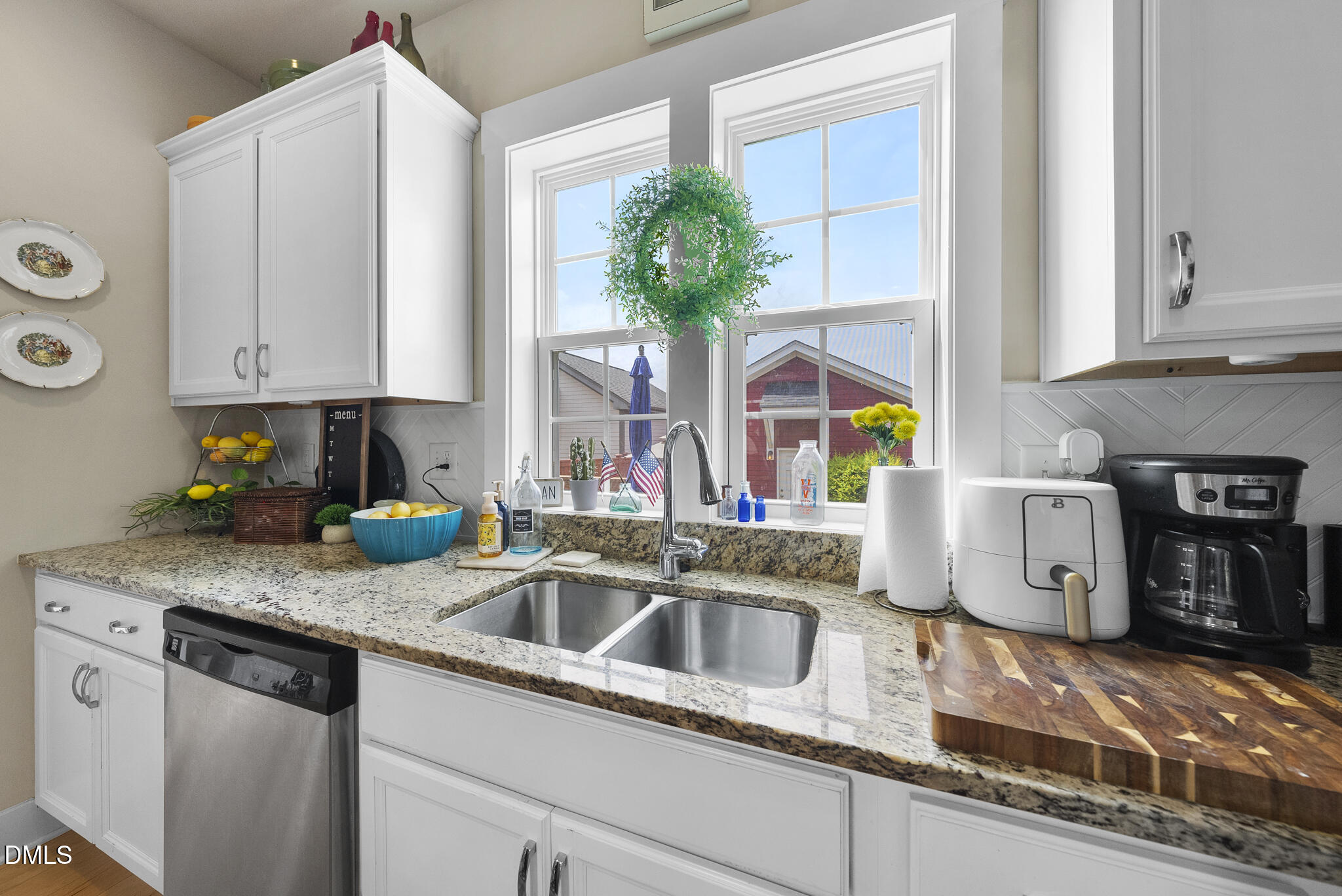 1985 Big Falls Drive Wendell, NC 27591 - Photo 4 of 24 a kitchen with stainless steel appliances granite countertop a sink a counter cabinets and a window
