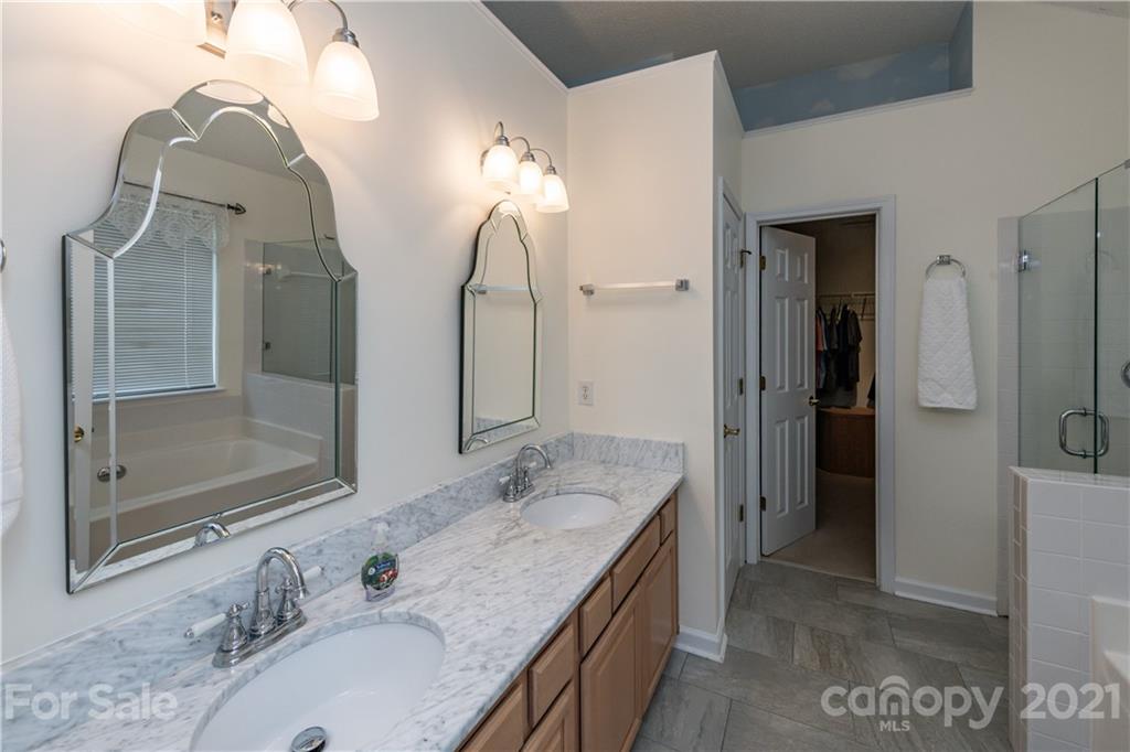 851 Knightsbridge Road Fort Mill, SC 29708 - Photo 22 of 34 a bathroom with a double vanity sink mirror and shower