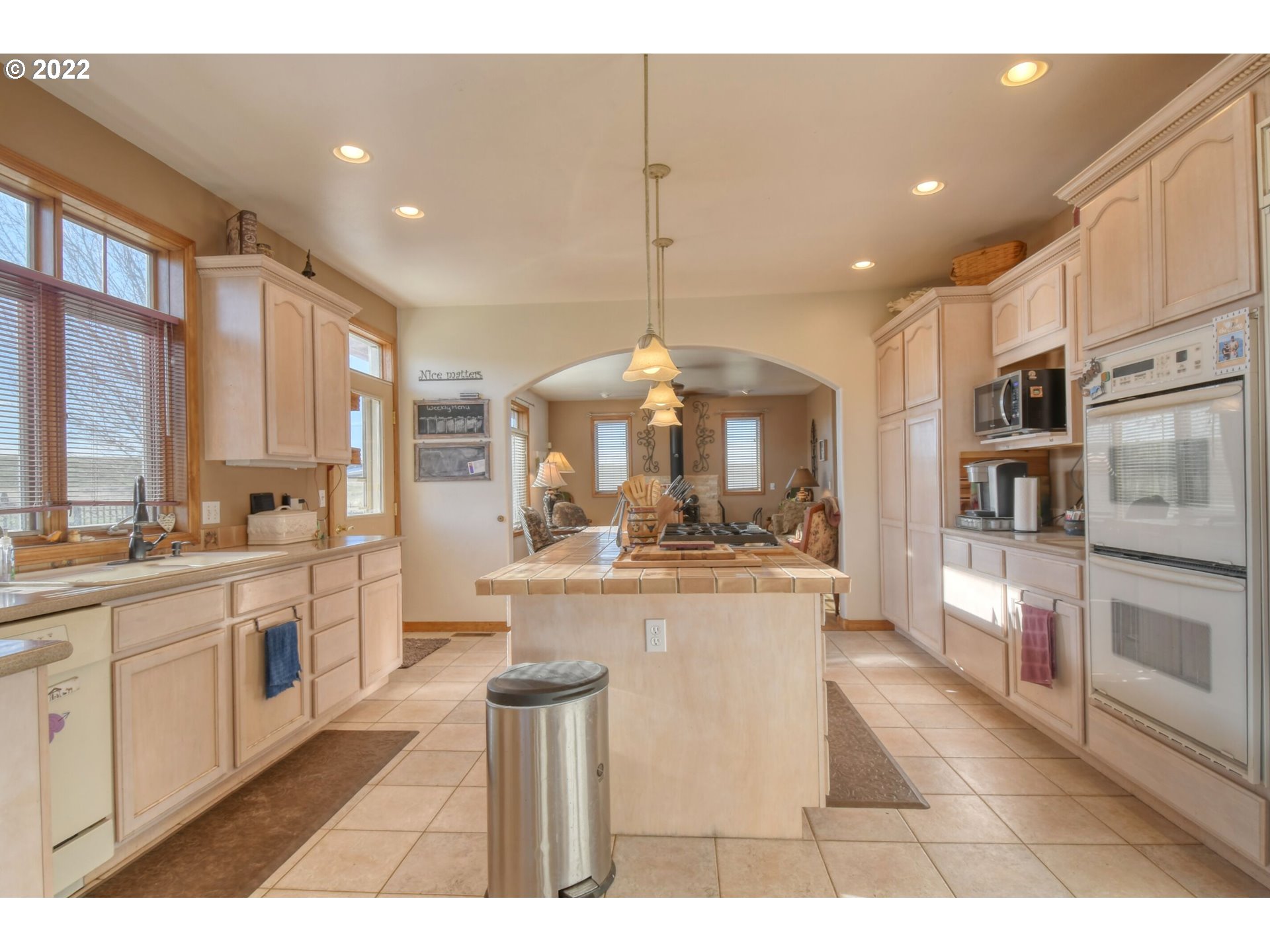 48903 Cayuse Road Pendleton, OR 97801 - Photo 21 of 32 a kitchen with stainless steel appliances kitchen island granite countertop a sink and cabinets