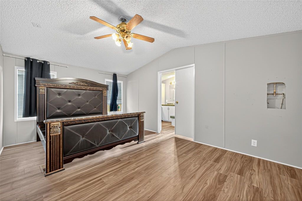 451 Trails End Drive Cleveland, TX 77328 - Photo 11 of 28 a living room with a flat screen tv a ceiling fan and wooden floor