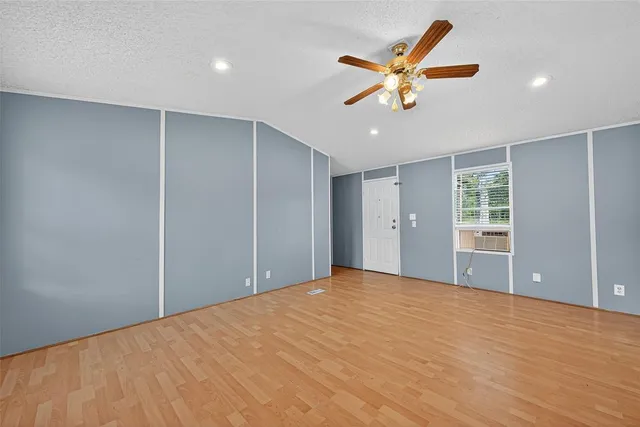 a view of an empty room with a ceiling fan