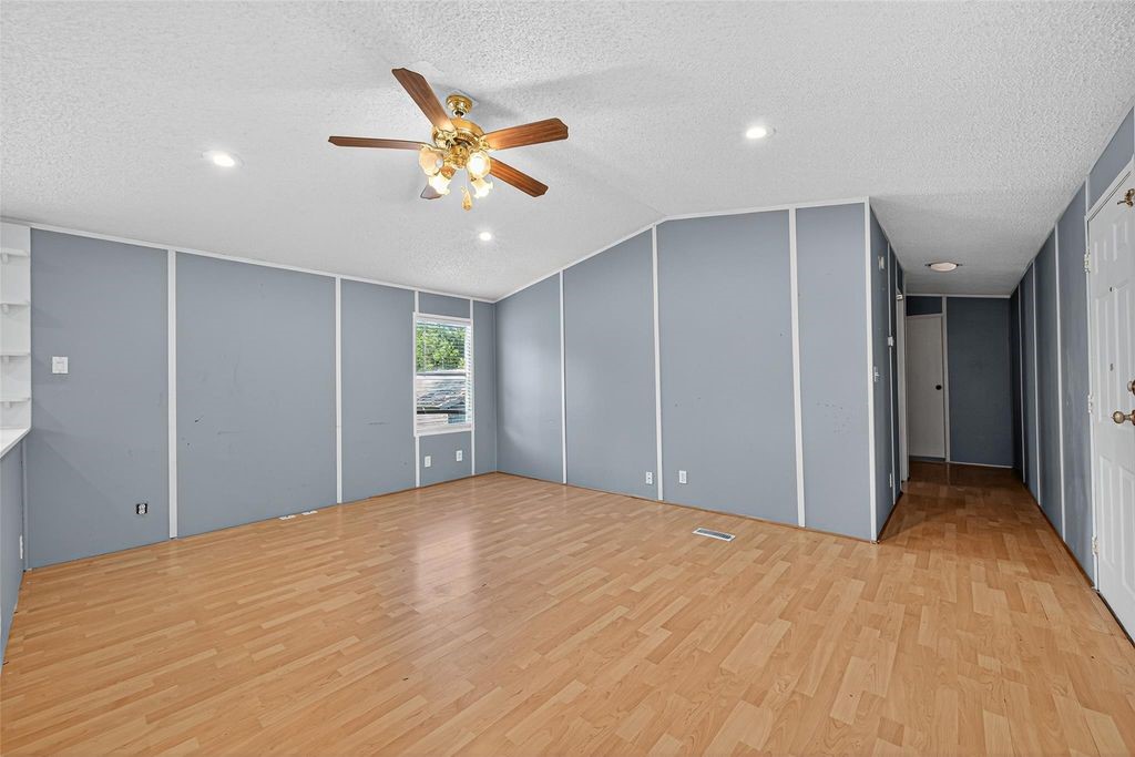 451 Trails End Drive Cleveland, TX 77328 - Photo 18 of 28 a view of empty room with wooden floor and ceiling fan