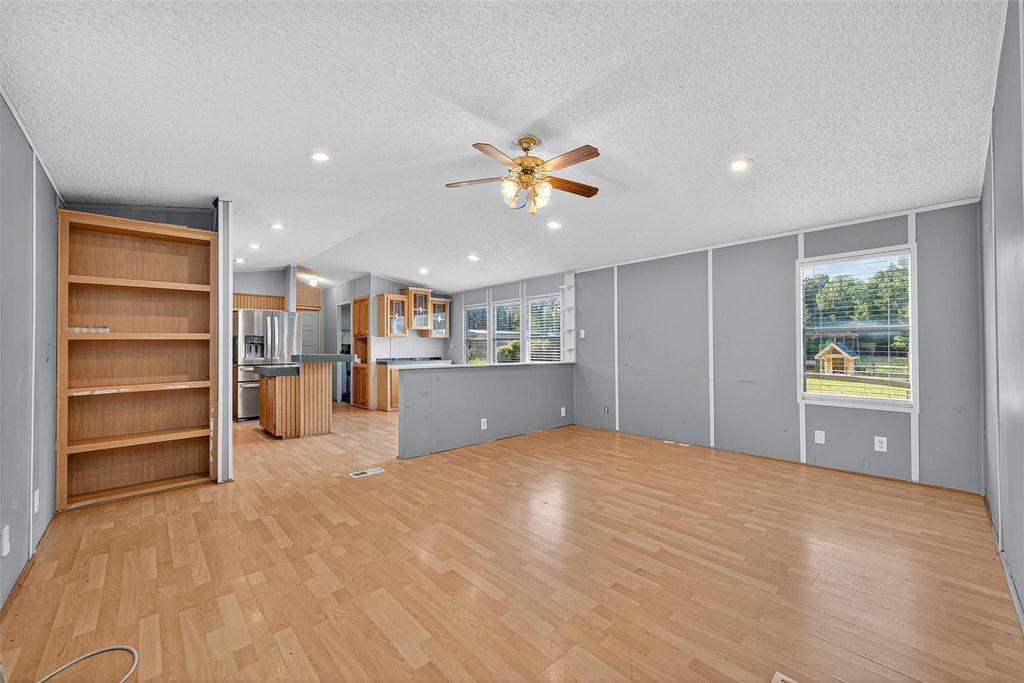 451 Trails End Drive Cleveland, TX 77328 - Photo 19 of 28 a view of a kitchen with a fridge and a window
