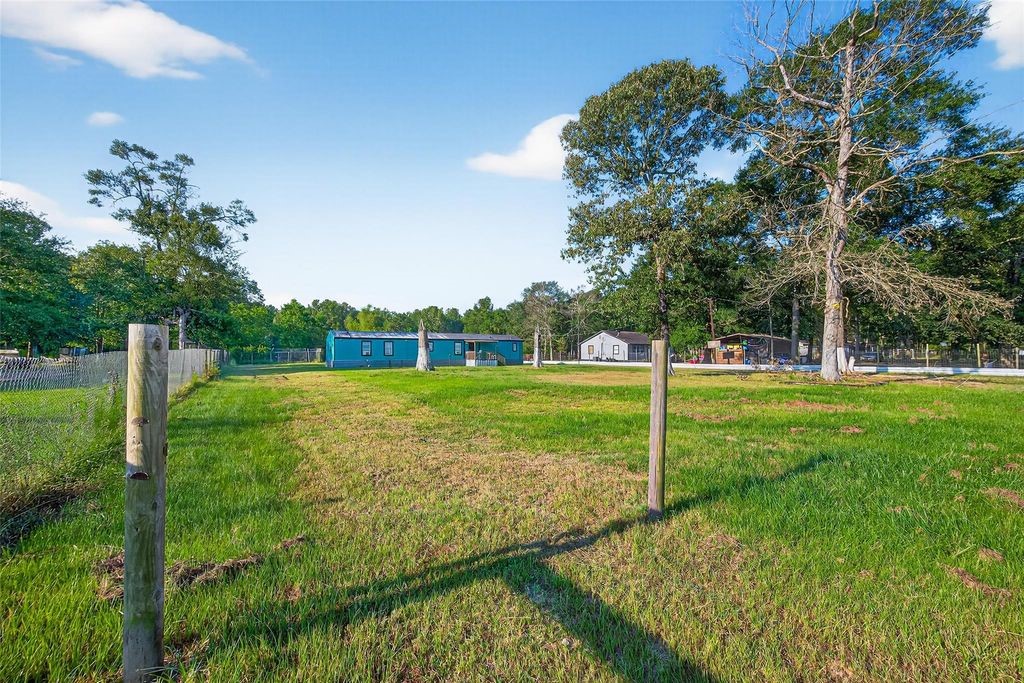451 Trails End Drive Cleveland, TX 77328 - Photo 20 of 28 a view of a park with plants and a large tree