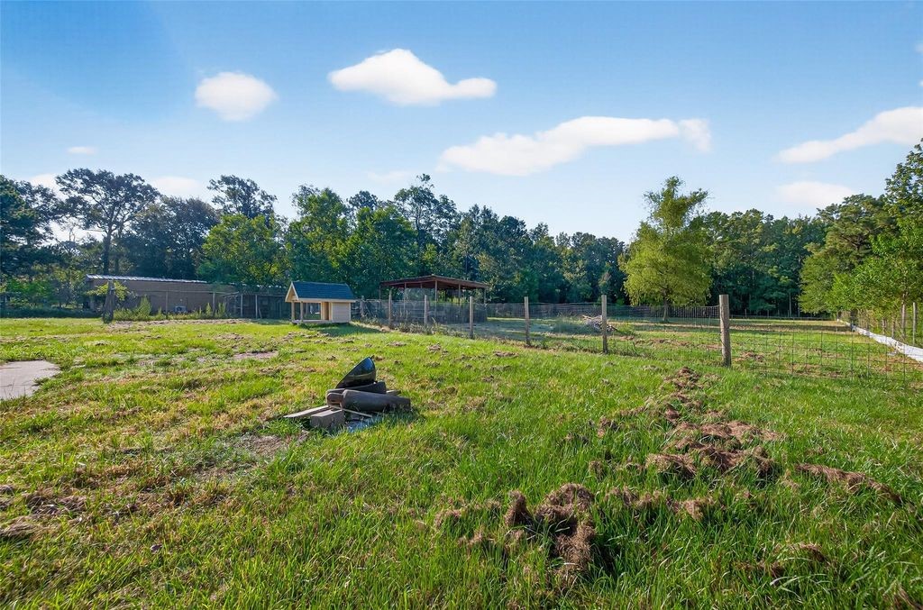 451 Trails End Drive Cleveland, TX 77328 - Photo 3 of 28 a swimming pool with some trees in the background