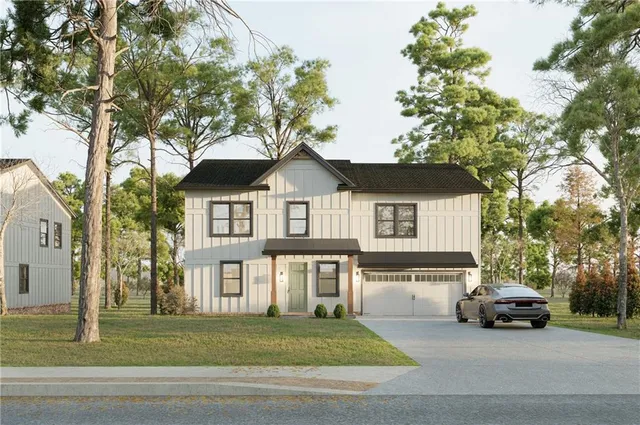 a front view of a house with a garden and trees