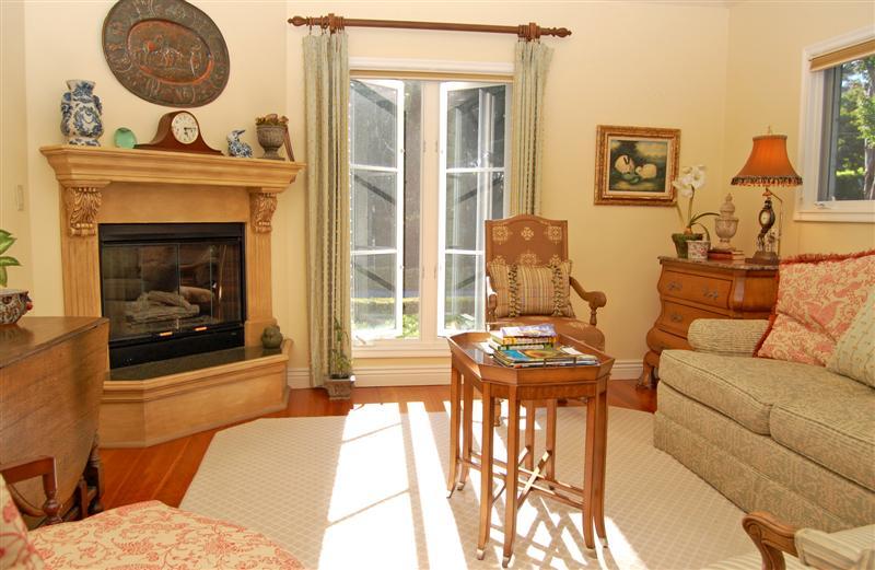 150 Middle Road Montecito, CA 93108 - Photo 5 of 12 a living room with furniture a fireplace and a floor to ceiling window