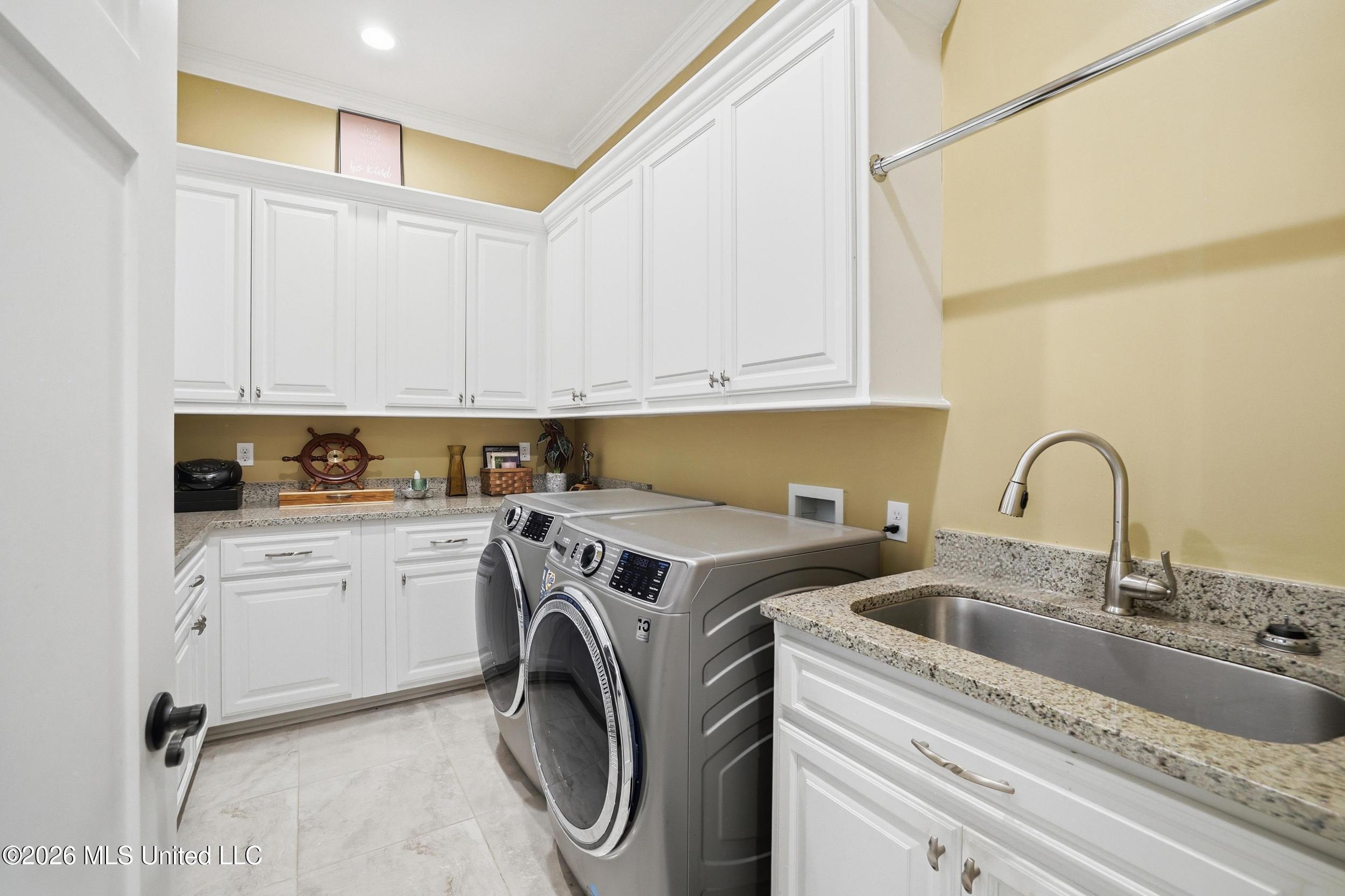 1584 Lucius Street Biloxi, MS 39532 - Photo 43 of 47 LAUNDRY ROOM WITH CUSTOM BUILT CABINETRY
