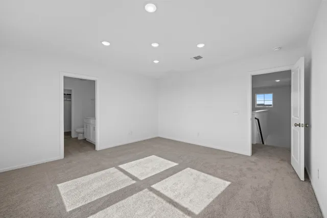 an empty room with closet and a bathroom