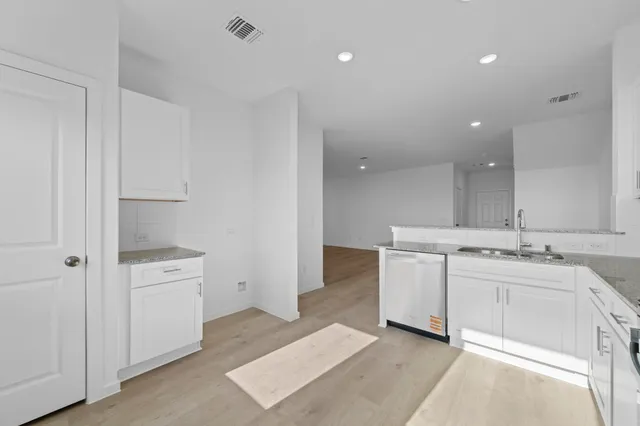 a view of a kitchen with white cabinets