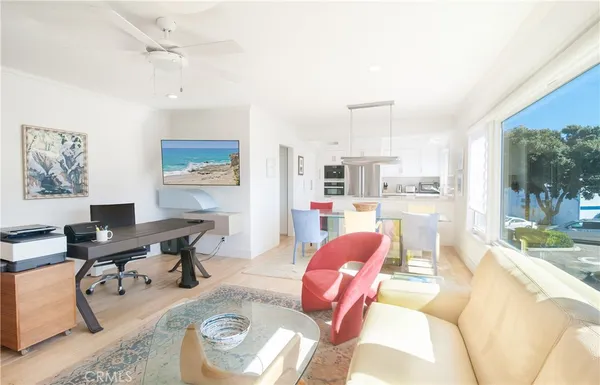 a living room with furniture a rug and white walls