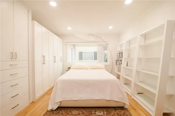 a spacious bedroom with a large bed and a walk in closet