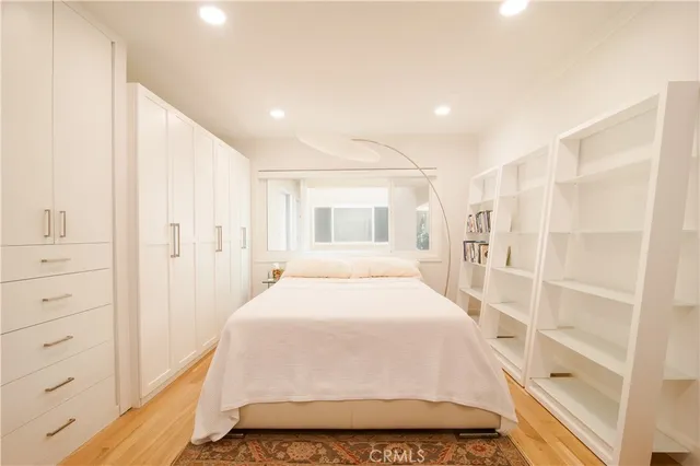 a spacious bedroom with a large bed and a walk in closet