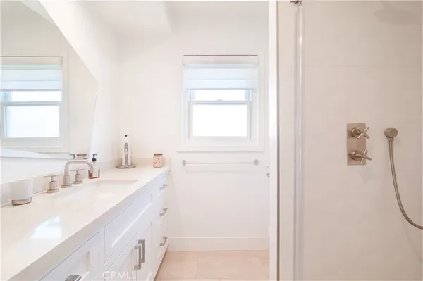 a bathroom with a sink a vanity and a mirror