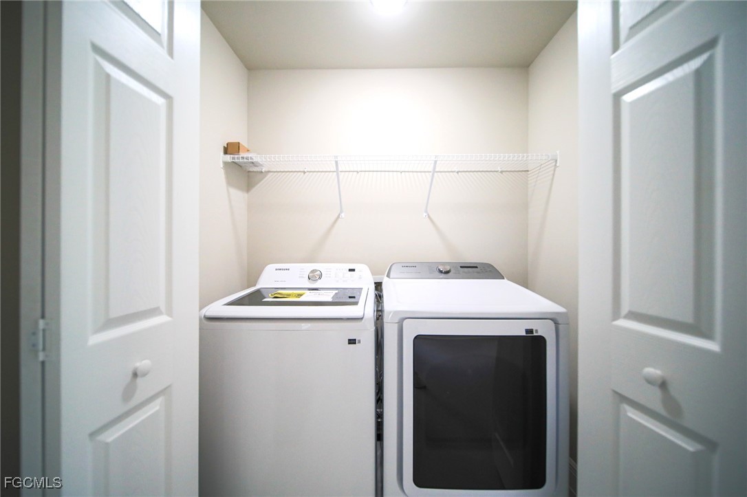 1018 Genoa Avenue South Lehigh Acres, FL 33974 - Photo 16 of 22 a utility room with dryer and washer